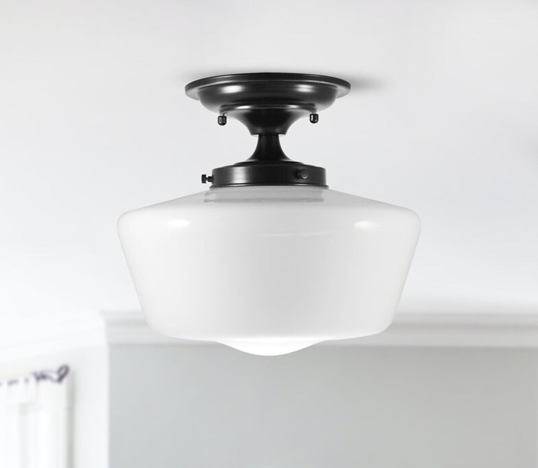 schoolhouse fixture made of metal and glass. Matte black finish and white opal schoolhouse glass. Elegant and timeless